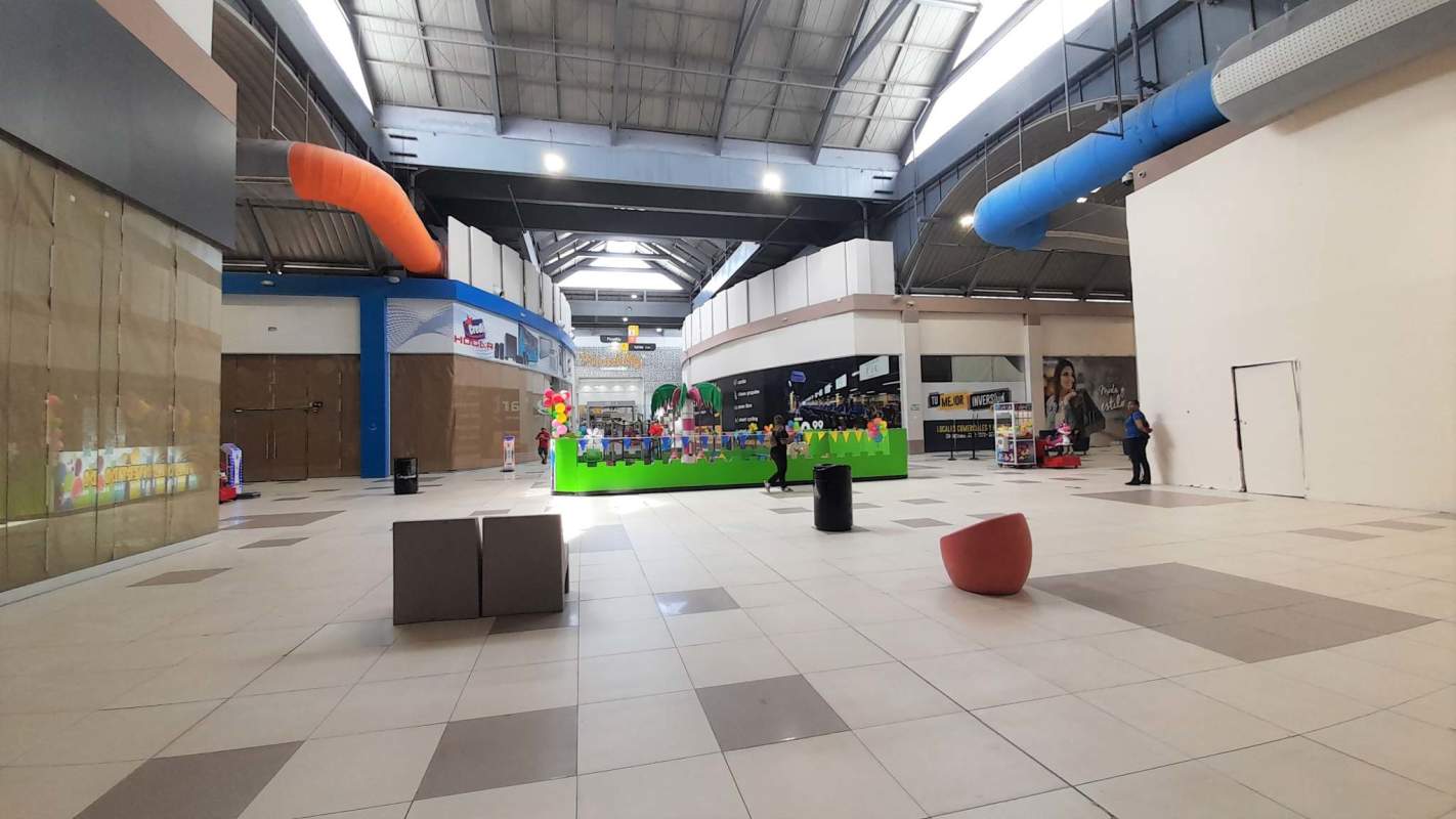 Colorful commercial shopping mall with play area and retail corridor MegaMall Panama