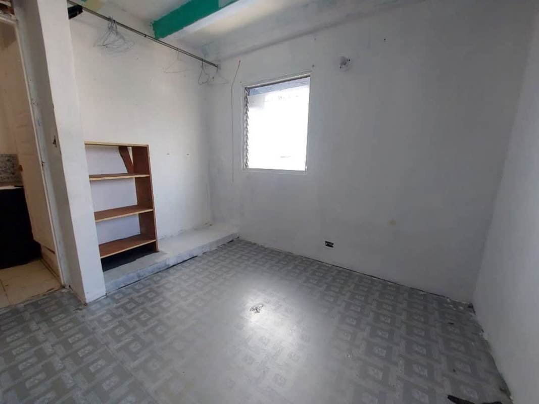 Simple bedroom with tile floor, open closet and window in PH Los Libertadores Panama City