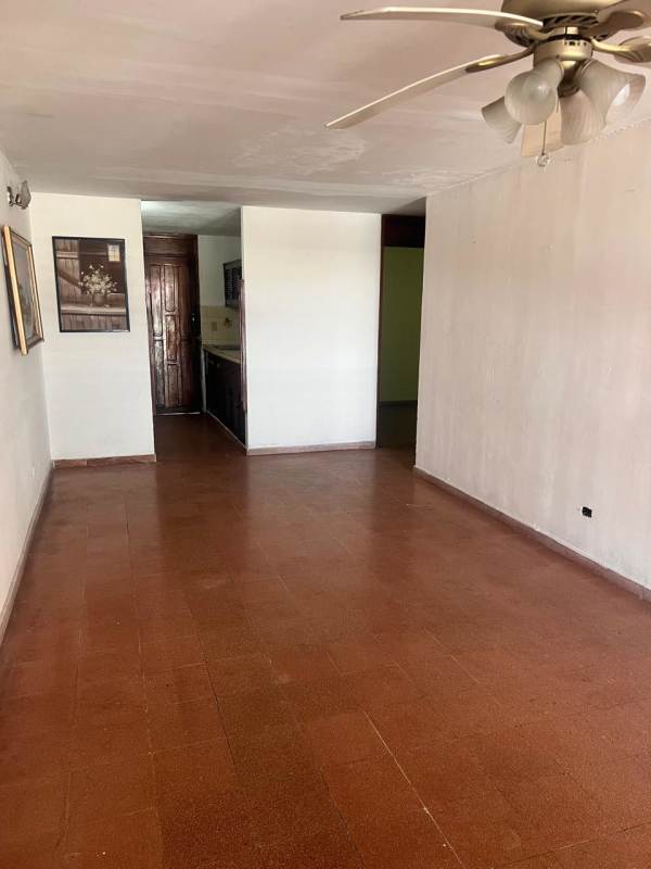 Bedroom with yellow walls, tiled floor, security window bars Don Bosco house Panama