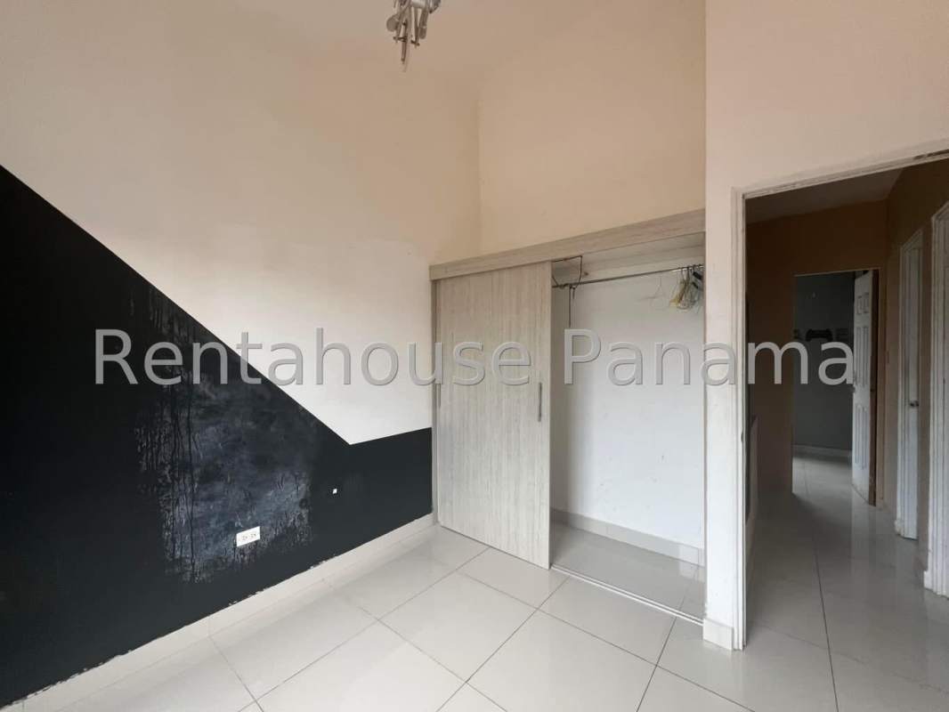 Bedroom with accent wall and built-in closet in Villa Zaita house