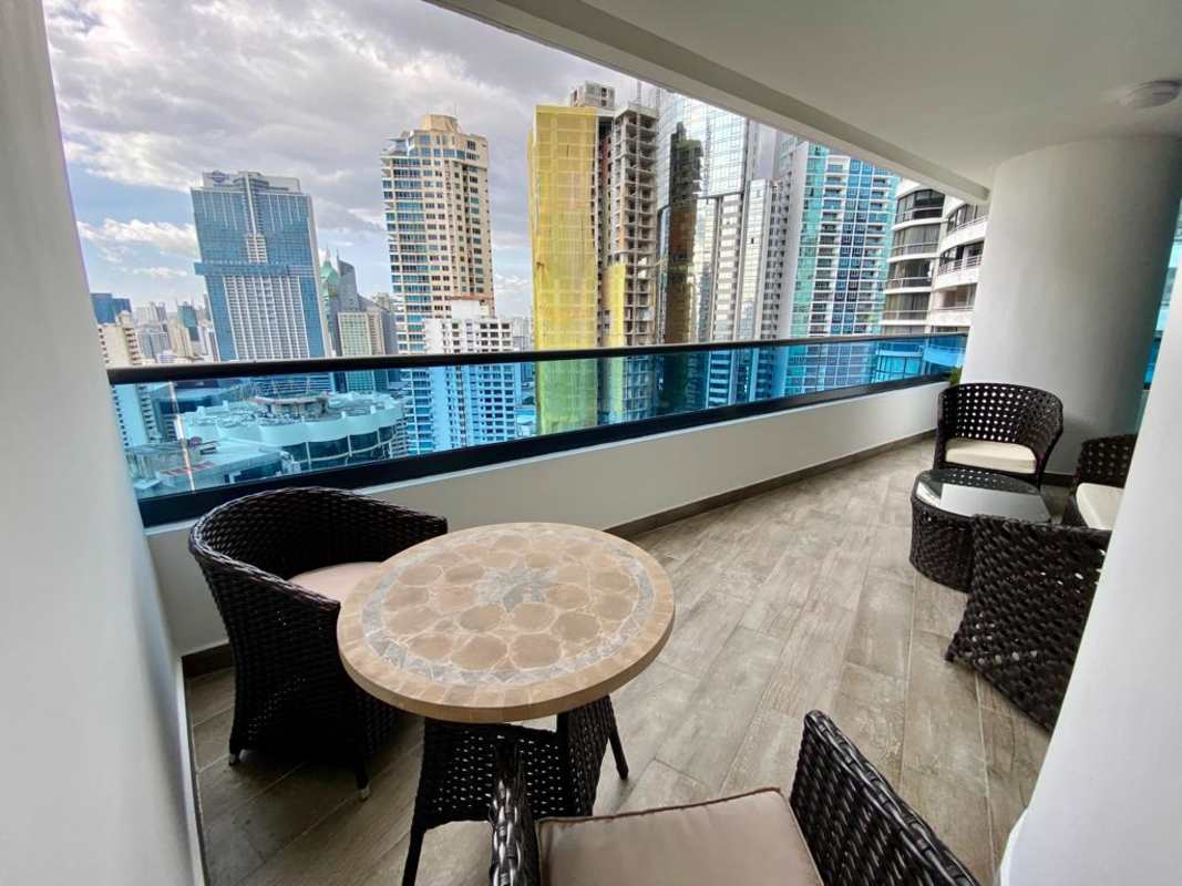 Modern dining area with large windows city skyline views blue chairs PH Punta Paitilla Panama