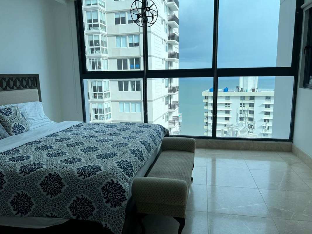 Bedroom with large windows city and ocean views modern decor PH Punta Paitilla Panama