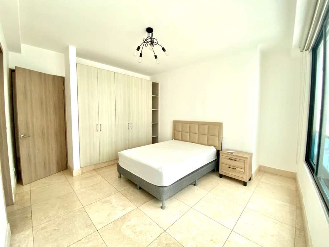 Contemporary bedroom with large window built-in wardrobe tiled floors PH Punta Paitilla Panama