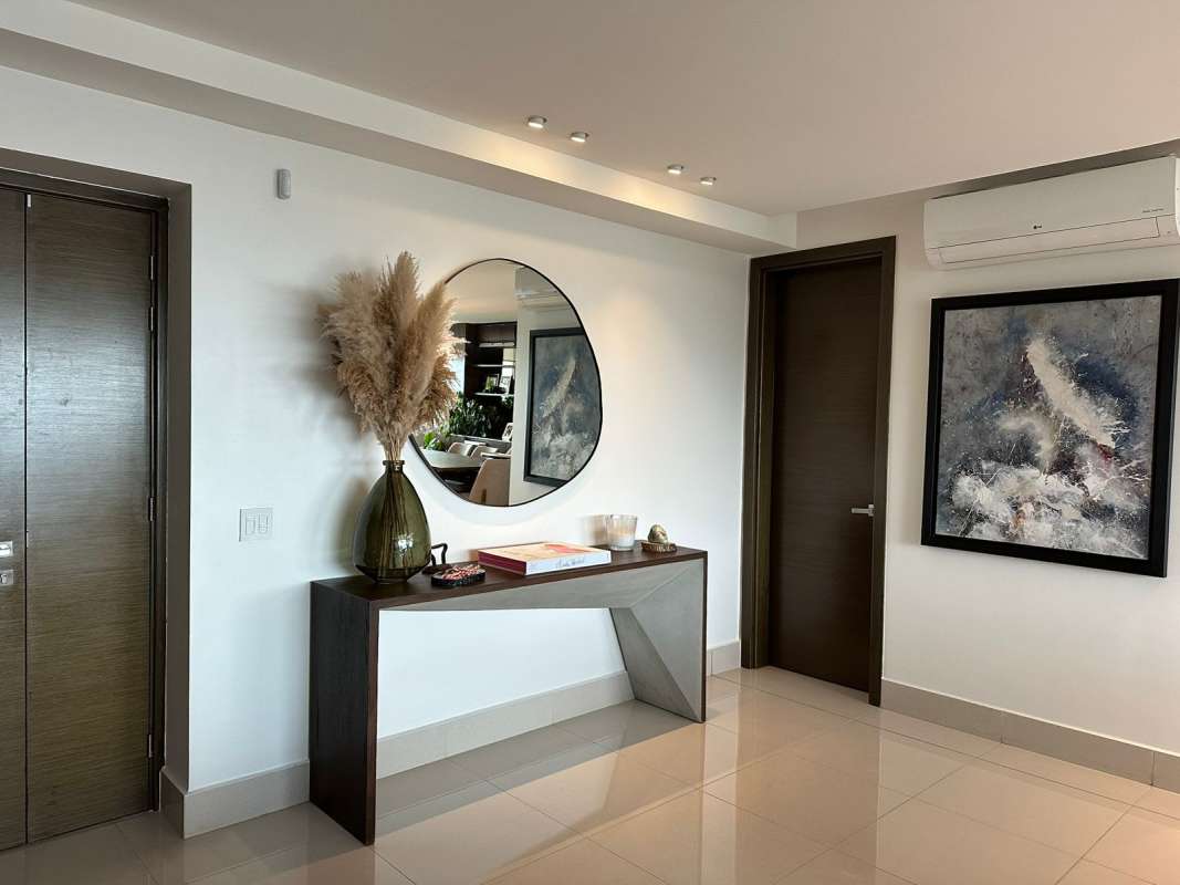 Apartment foyer with mirror and console table at PH Bali Costa del Este Panama
