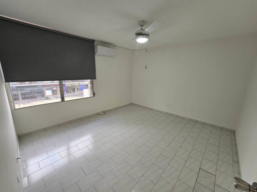 Empty bedroom with ceiling fan, tile floor, window PH Ocean View San Francisco Panama