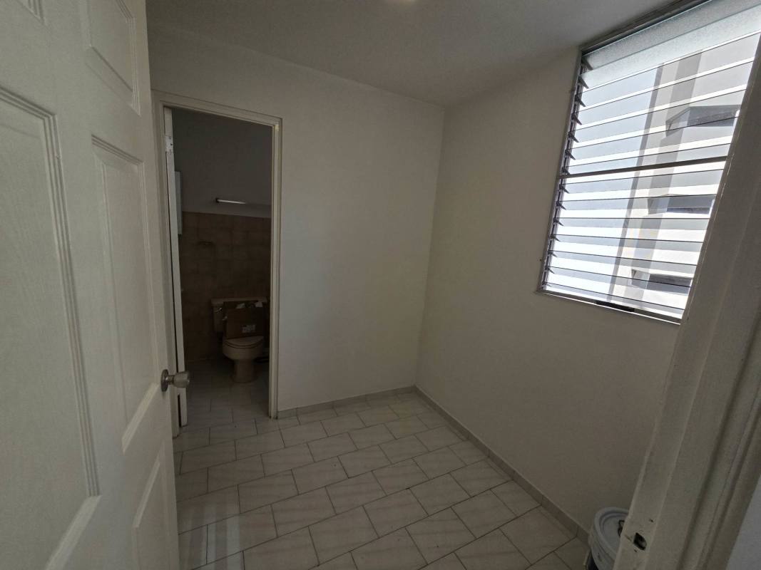 Utility laundry room with sink, water heater, window PH Ocean View apartment San Francisco