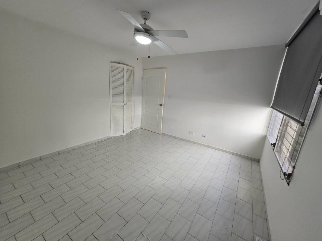 Bedroom with ceiling fan, closet, tile floor in PH Ocean View for rent Panama