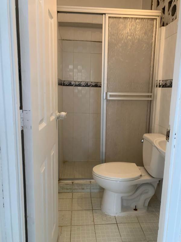 Small bathroom shower enclosure toilet rent apartment Tocumen Panama