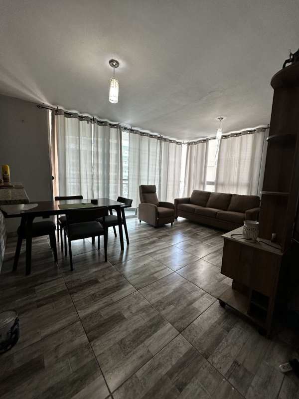 Modern living room with brown sofas ceramic tile floors TV PH Belview Towers Edison Park Panama City