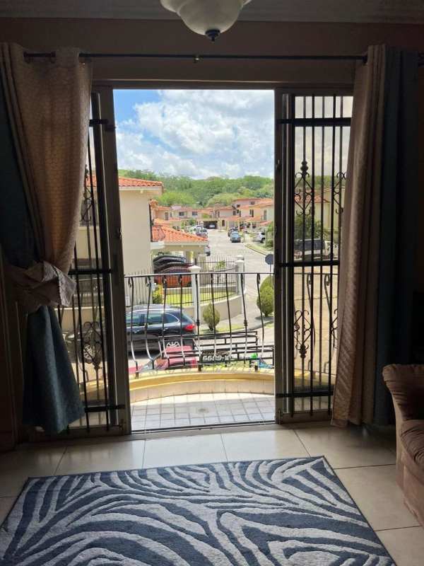Balcony with ironwork overlooks lush garden in Paseo Dorado community Dorado Lake Panama