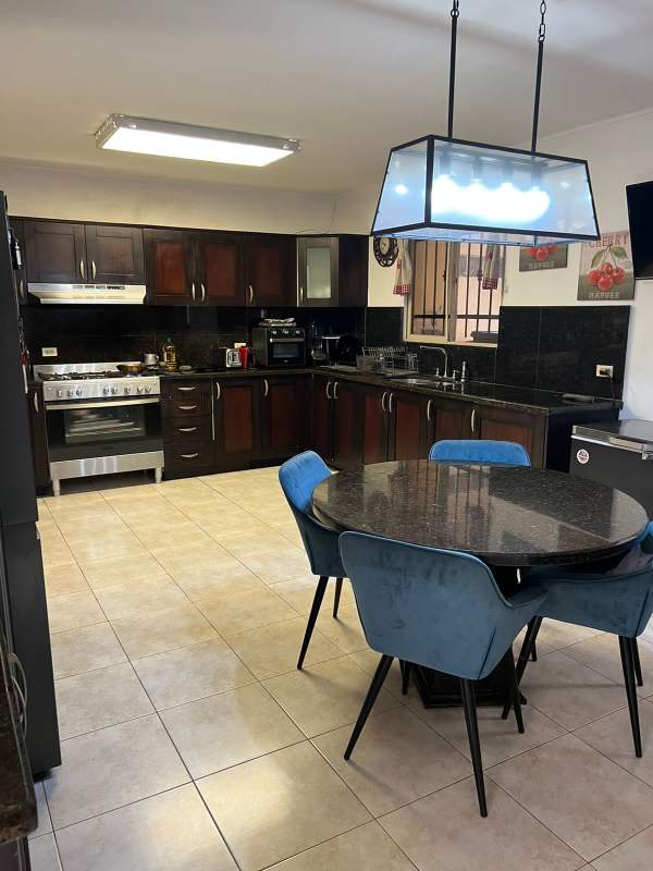 Bedroom with tile floor, split AC and large window featuring security bars in Paseo Dorado house Panama