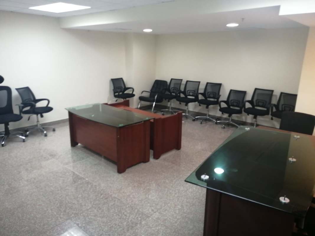 Workspace with glass desks black mesh chairs modern lighting Costa del Este Panama