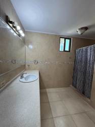 Modern beige tiled bathroom large mirror vanity at Playa Blanca Resort Panama beach condo for sale