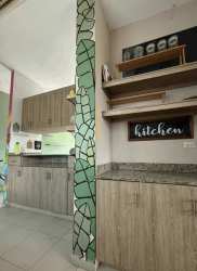 Rustic kitchen design with granite countertops green backsplash at Playa Blanca Resort apartment Panama
