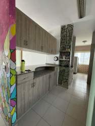 Modern kitchen with granite counters tile walls Playa Blanca ground floor apartment Panama beach property