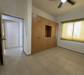 Bedroom with large window and built-in closet in PH Playa Blanca Condo in Panama beach area
