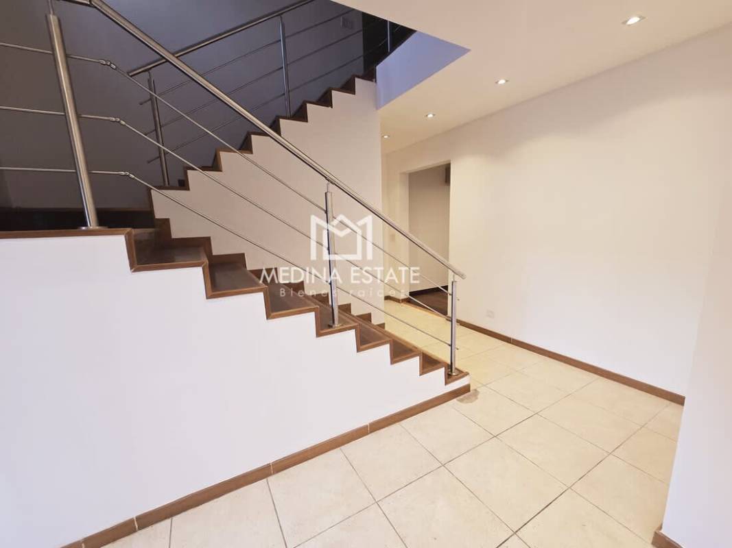 Contemporary kitchen with granite island wood cabinetry stainless appliances at Clayton Embassy Club home