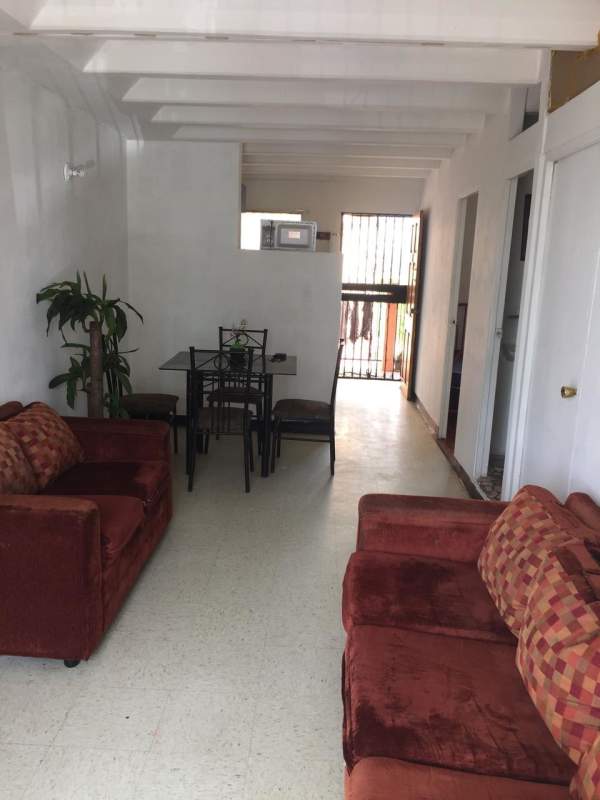 Simple living area with sofa and natural light in Villa Gabriela Río Abajo Panama