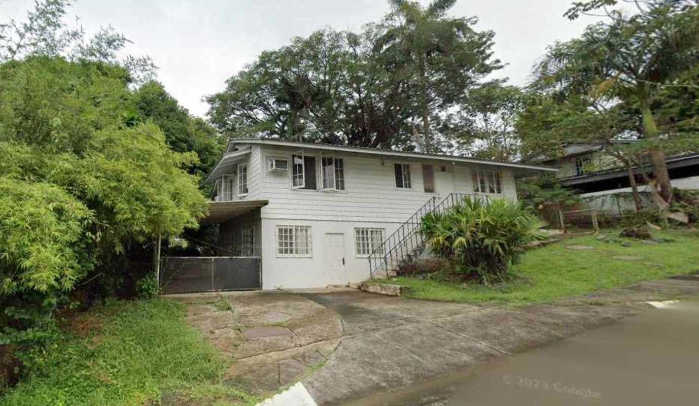 Two-story traditional house with mature trees and yard in Ancón Panama