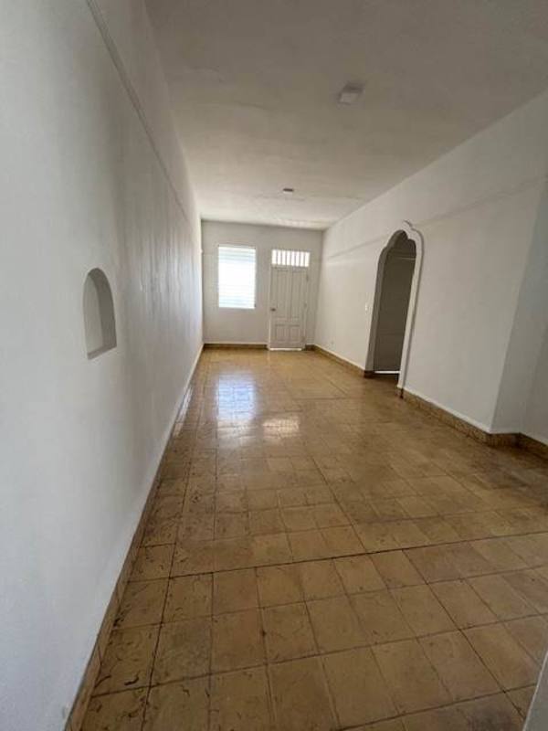 Apartment entry hall with archway, tile floors, large window Perejil Panama