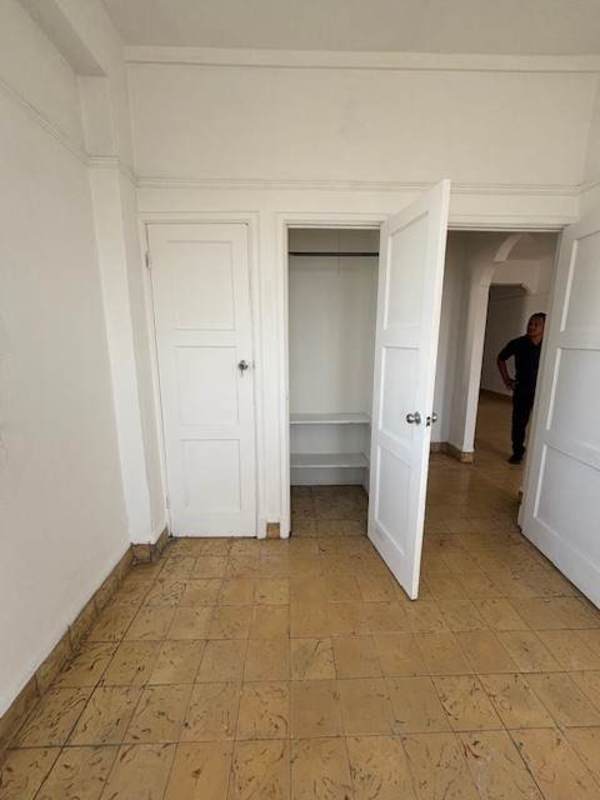 Small bathroom with blue trim tiles and pedestal sink Perejil Panama City
