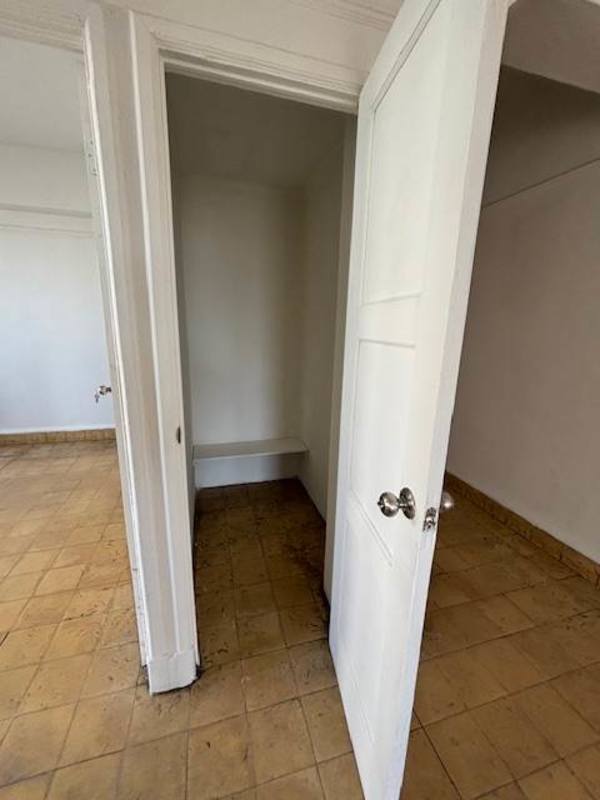Built-in white closet with open doors in Perejil Panama rental apartment
