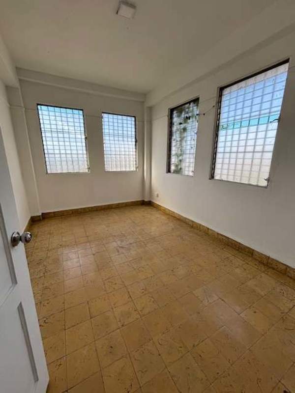 Bright room with large windows bars tile floor Perejil apartment Panama City