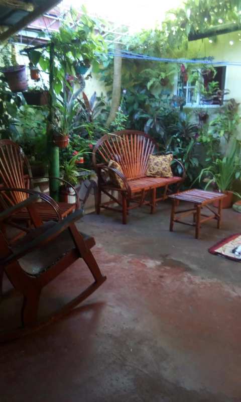 Kitchen with patterned tile floor, wooden cabinets, stove and refrigerator Villa Grecia Panama