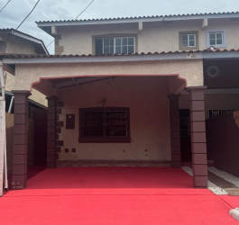 Front porch of townhouse duplex with tiled roof, arched entrance, beige walls Vista Alegre Arraiján Panama