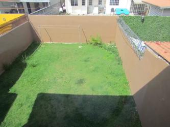 Living room with ceramic floors brown sofa large windows duplex townhouse Arraiján Panama