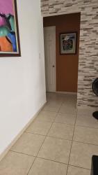 Ceramic tile hallway with stone accent wall at Las Magnolias house Costa Verde Panama