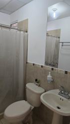 Bathroom with pedestal sink, shower curtain affordable house Costa Verde Panama