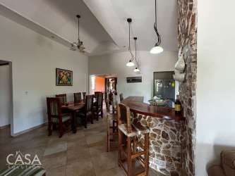 Traditional wood kitchen with granite island and large window in Coclé Panama countryside home