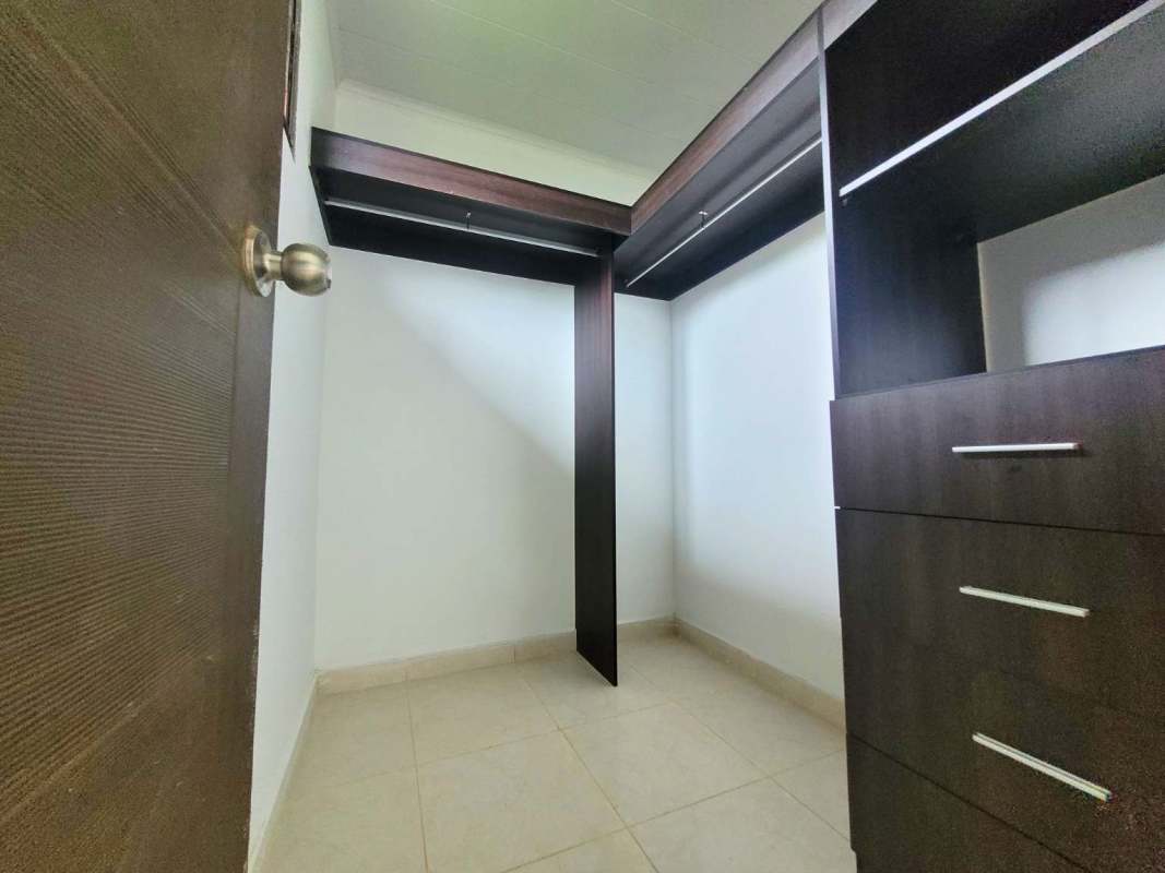 Kitchen with granite countertops dark wood cabinets at PH Paseo del Rey Arraiján Panama