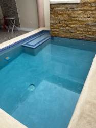 Small backyard splash pool with stone accent wall and patio in Playa Leona Chorrera Panama rental house