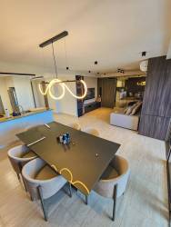 Bright modern living dining room with wood panels and terrace view PH Explora Panama Pacifico