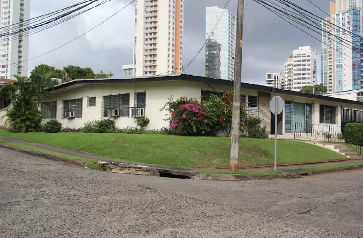 Bright living room with large windows, tile floors, traditional decor in San Francisco Panama house