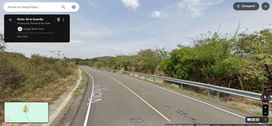 Curved asphalt rural road with metal guardrail and dense vegetation near Sardinas Penonomé Coclé Panama