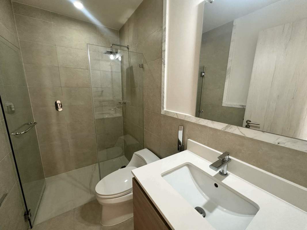 Modern luxury bathroom with glass shower and beige tiles in Ocean House Santa Maria Panama