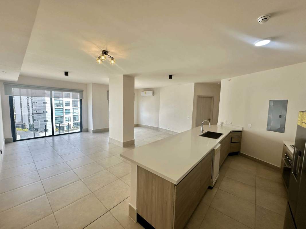 Spacious living dining room with balcony access and modern kitchen in Ocean House Panama City