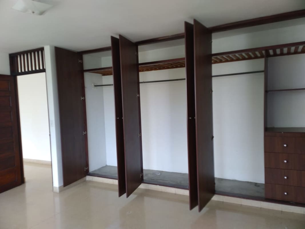 Bright kitchen with louvered windows brown cabinetry PH Vía Argentina Residences