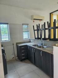 Modern kitchen with granite countertops, dark cabinetry, and stainless sink in PH Napa Village Playa Blanca Panama
