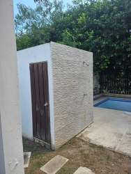 Outdoor shower beside lush garden and swimming pool in PH Napa Village Playa Blanca Panama