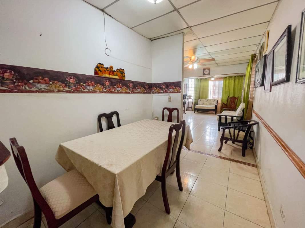 Traditional kitchen with tiled counters and wood cabinets in San Miguelito house for sale