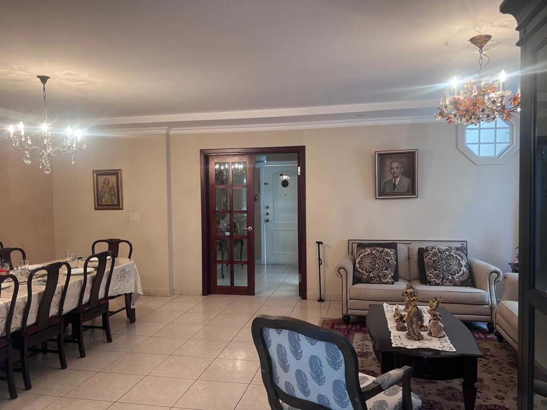 Living room Costa Dorada with tiled floors, chandeliers, large windows and combined dining space in Costa del Este house Panama