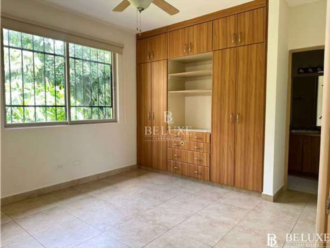 Modern bathroom with glass shower, granite counter, wood vanity PH Embassy Garden Clayton Panama