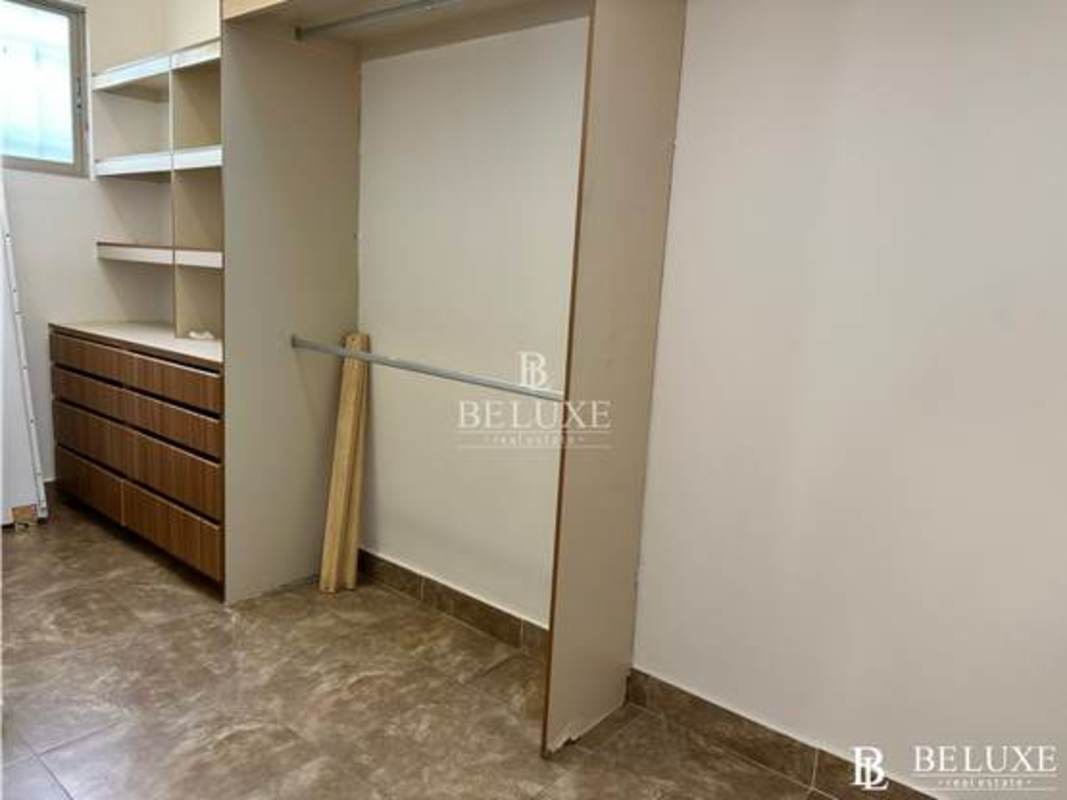 Large kitchen with granite countertops, wood cabinets, window, tile floor in Clayton Panama Embassy Garden house