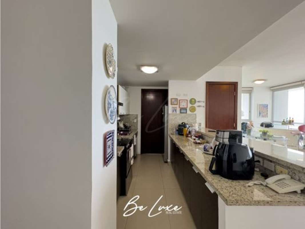 Glass dining table with panoramic ocean view through large windows at PH Oceanaire Panama