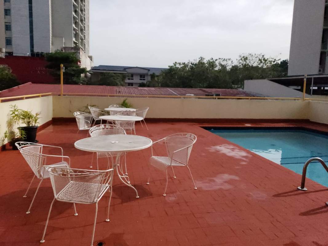 Rooftop swimming pool with patio chairs, city view PH El Dorado Panama City