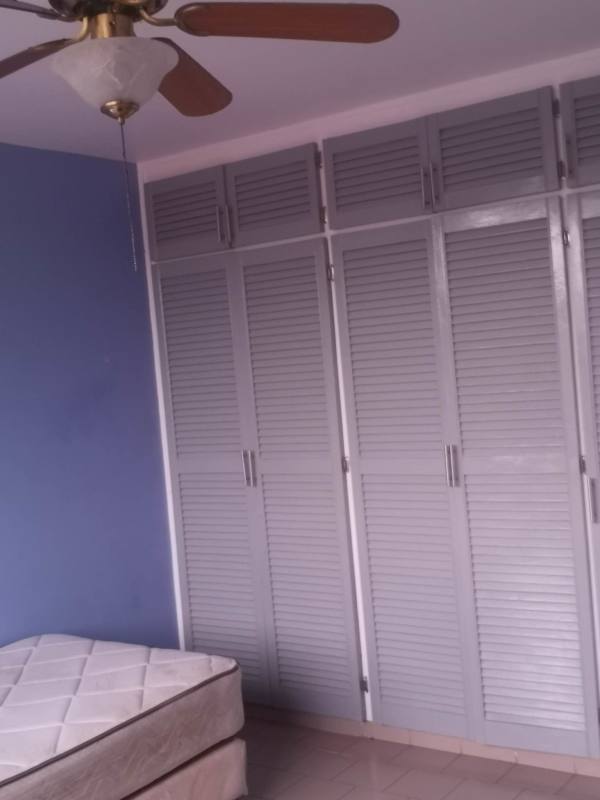 Bedroom with tile floors, blue and white walls, closet, ceiling fan, AC unit in PH El Dorado Panama City